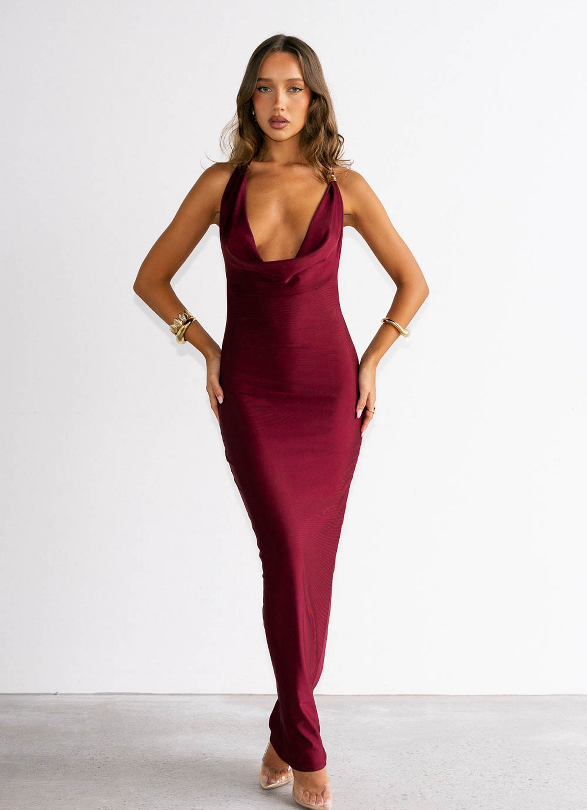 Woman wearing a burgundy dress against a white background