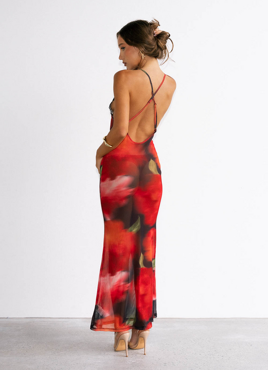 Woman wearing a red floral dress with a white background