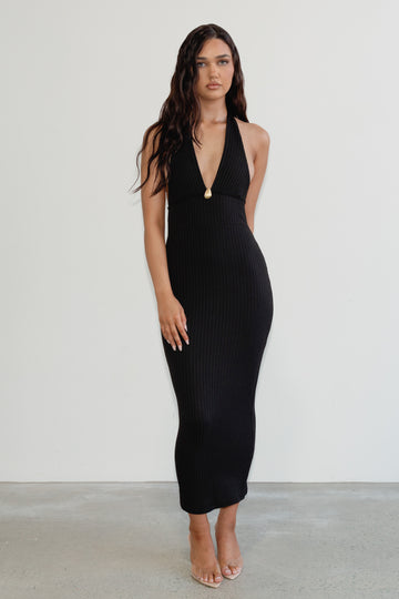 Woman wearing a black dress against a white background