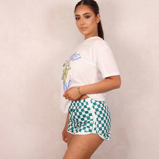 Model wearing a graphic tee and shorts set.