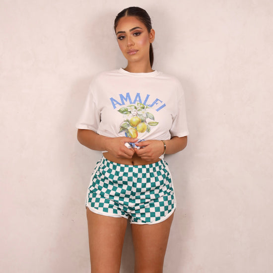 Model wearing a graphic tee and shorts set.